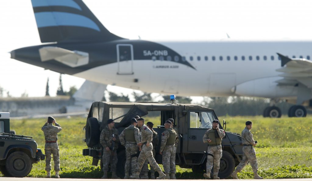 Maltese troops survey a hijacked Libyan Afriqiyah Airways Airbus A320 on the runway at Malta Airport, December 23, 2016. REUTERS/Darrin Zamit-Lupi MALTA OUT - RTX2W9Q3