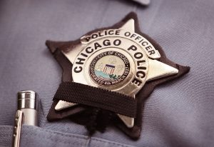 A black band is stretched across a District 1 Chicago Police officer's badge to mourn the death of a fellow officer on July 19, 2010 in Chicago, Illinois. District 1 officer Michael Bailey was killed in front of his home after getting off duty Sunday morning in what appeared to be an attempted carjacking. Bailey was the third Chicago police officer shot and killed since mid-May. (Photo by Scott Olson/Getty Images)