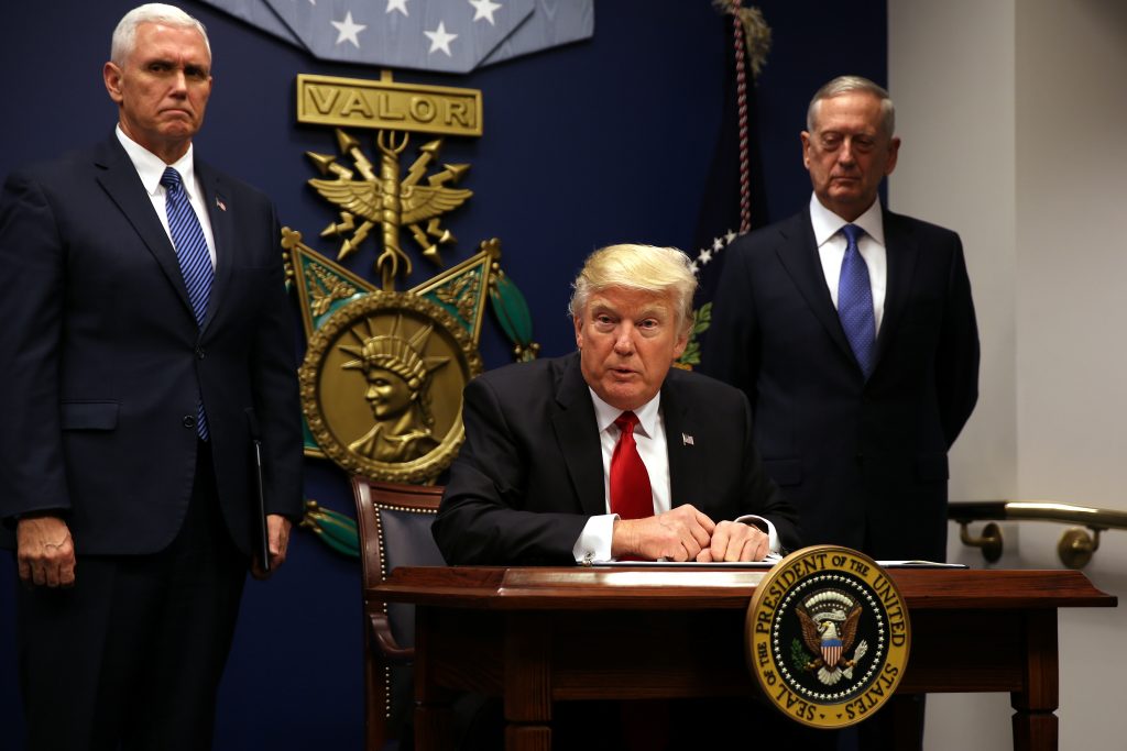 U.S. President Donald Trump signs an executive order to impose tighter vetting of travelers entering the United States, at...