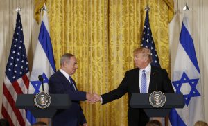 U.S. President Donald Trump (R) greets Israeli Prime Minister Benjamin Netanyahu after a joint news conference Feb. 15 at the White House in Washington, D.C. Photo by REUTERS/Kevin Lamarque  - RTSYUDS