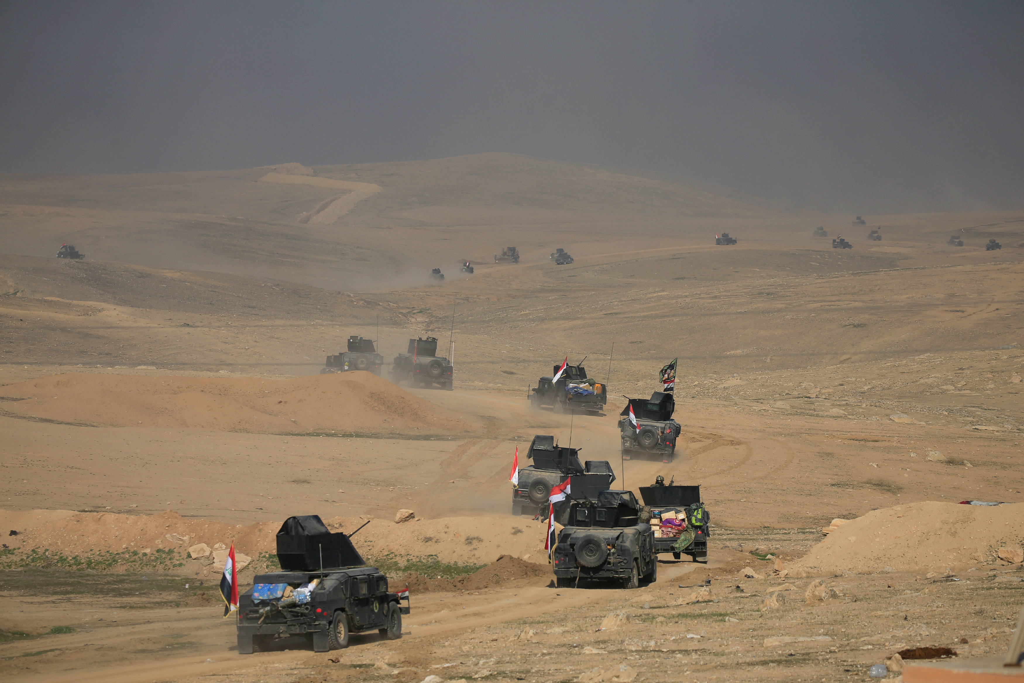 Counterterrorism service troops advance toward the Ghozlani military complex, south of Mosul, Iraq on Feb. 23. Photo by Alaa Al-Marjani/Reuters