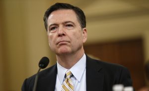 FBI Director James Comey waits before testifying at a House Intelligence Committee hearing into alleged Russian meddling in the 2016 U.S. election, on Capitol Hill in Washington, U.S., March 20, 2017. REUTERS/Joshua Roberts.