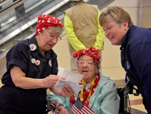The Army Engineer Spouses Club welcome a group of more than 30 Michigan-based "Rosie the Riveters" at Ronald Reagan International Airport in Arlington, Virginia, U.S., March 22, 2016. Photo by Cynthia Mitchell/U.S. Army Corps of Engineers, Baltimore District/Handout via Reuters