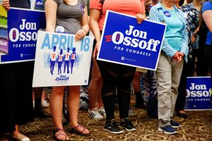 Supporters of Democratic candidate Jon Ossoff, running for Georgia's 6th Congressional District special election to to fill the seat of Republican Tom Price who was appointed as secretary of Health and Human Services, listen to him speak during an election eve rally at Andretti Indoor Karting and Games in Roswell, Georgia, U.S. April 17, 2017. Picture taken April 17, 2017. REUTERS/Kevin D. Liles - RTS12SL4