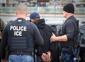 ICE officers detain a suspect as they conduct a targeted enforcement operation in Los Angeles