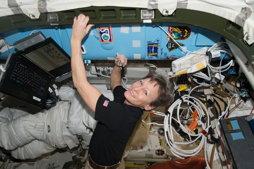 Astronaut Peggy Whitson signs a bulkhead on the International Space Station, as she breaks the U.S. record for cumulative ...