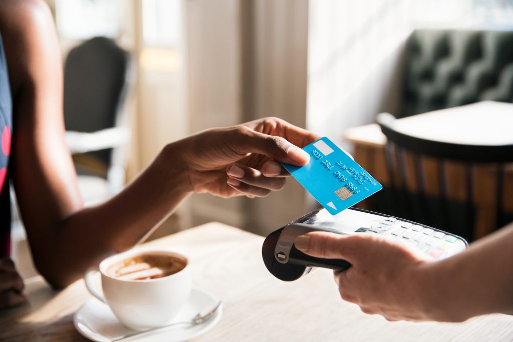 Woman using contactless payment, close up Photo by Tim Robberts/Getty Images
