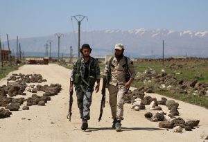 Free Syrian Army fighters walk in the northern province of Quneitra, Syria, on April 18. Photo by Alaa Al-Faqir/Reuters