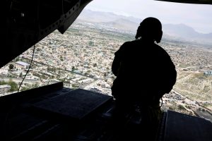 A soldier mans a gun at the back gate aboard the helicopter carrying Mattis as he arrives via helicopter at Resolute Support headquarters in Kabul