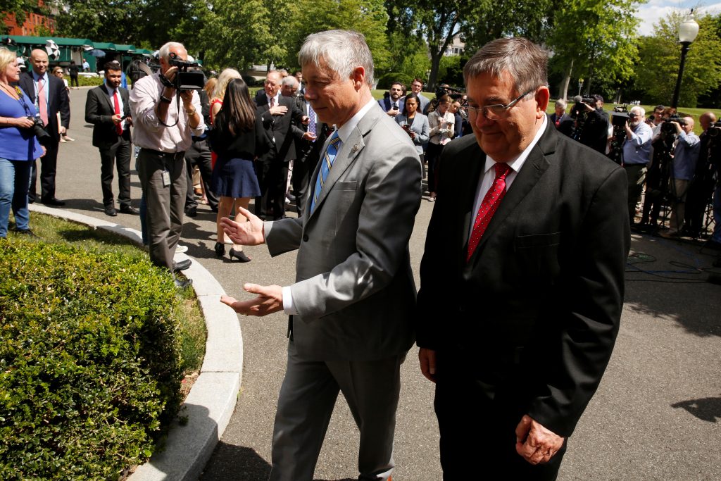 Reps. Fred Upton (R-MI) (C) and Michael Burgess (R-TX) (R) return to the West Wing after speaking to reporters about healt...