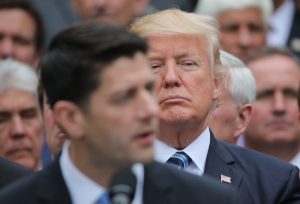U.S. President Donald Trump (C) listens to House Speaker Paul Ryan (L) as he gathers with Congressional Republicans in the Rose Garden of the White House after the House of Representatives approved the American Healthcare Act, to repeal major parts of Obamacare and replace it with the Republican healthcare plan, in Washington, U.S., May 4, 2017. REUTERS/Carlos Barria - RTS157M3