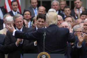 U.S. President Donald Trump (C) turns to House Speaker Paul Ryan (3rdL) as he gathers with Congressional Republicans in the Rose Garden of the White House after the House of Representatives approved the American Healthcare Act, to repeal major parts of Obamacare and replace it with the Republican healthcare plan, in Washington, U.S., May 4, 2017. Photo by Carlos Barria/REUTERS
