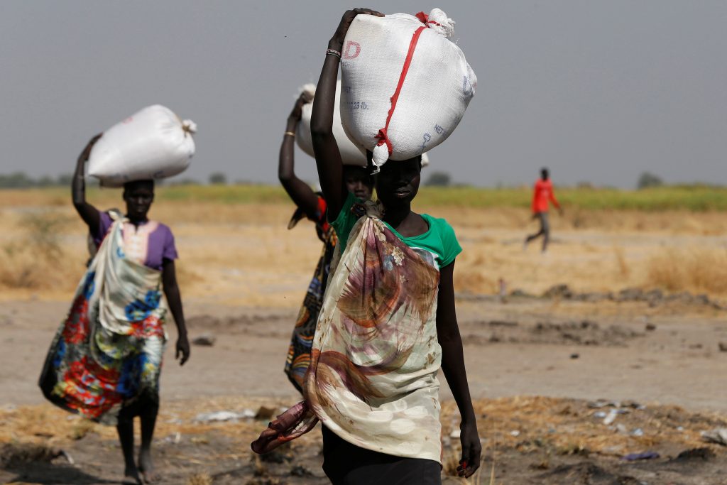 Women carry sacks of food in Nimini village, Unity State, northern South Sudan, February 8, 2017. Picture taken on February 8, 2017. REUTERS/Siegfried Modola - RTSZG0E