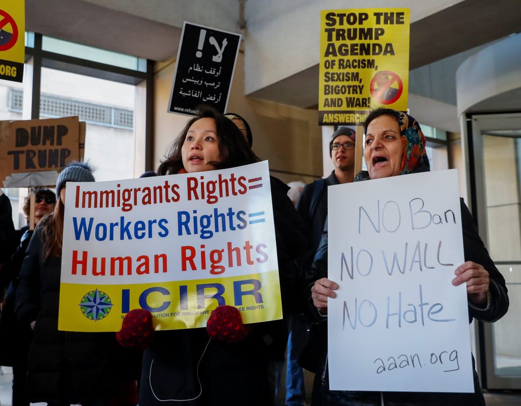 Demonstrators protest against President Donald Trump's revised travel ban in Chicago