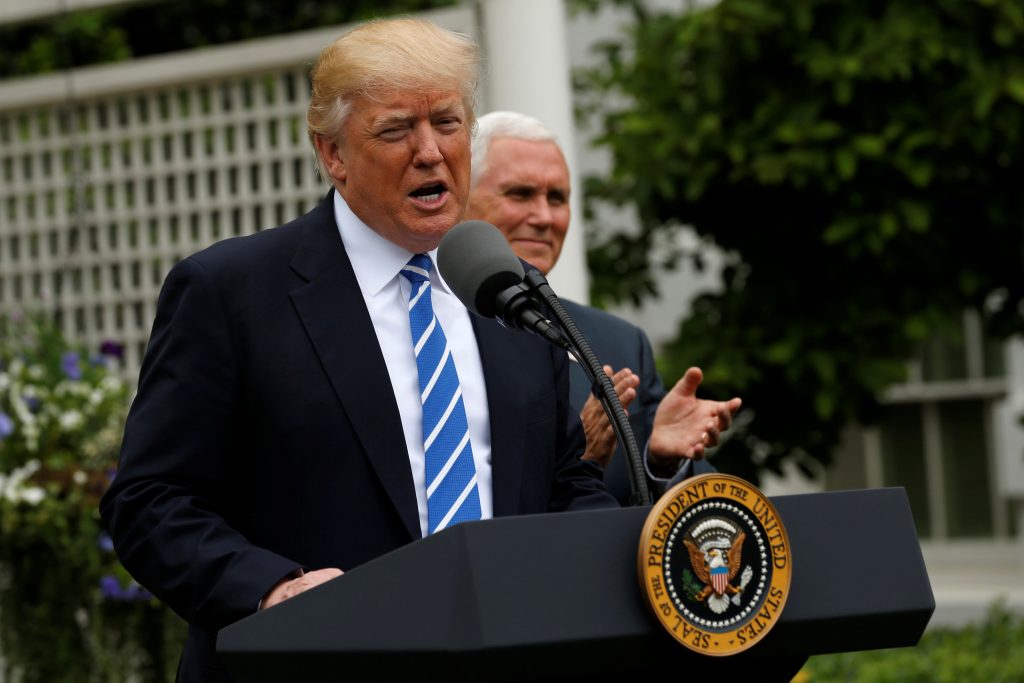 U.S. President Donald Trump, flanked by Vice President Mike Pence, delivers remarks to members of the Independent Communit...