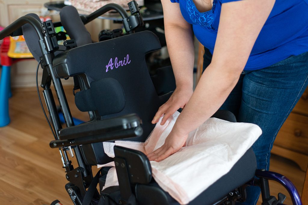 Sonia, 29, prepares Abril’s wheelchair on April 5, 2017. Abril can’t walk and needs a special wheelchair to get around. (H...