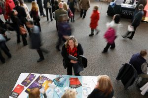 FILE PHOTO: A job seeker talks to an exhibitor at the Colorado Hospital Association health care career fair in Denver