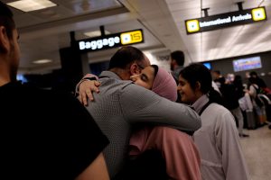 A Saudi family embraces as members arrive at Washington Dulles International Airport after the U.S. Supreme Court granted parts of the Trump administration's emergency request to put its travel ban into effect later in the week pending further judicial review, in Dulles, Virginia, U.S., June 26, 2017. REUTERS/James Lawler Duggan - RTS18QR3