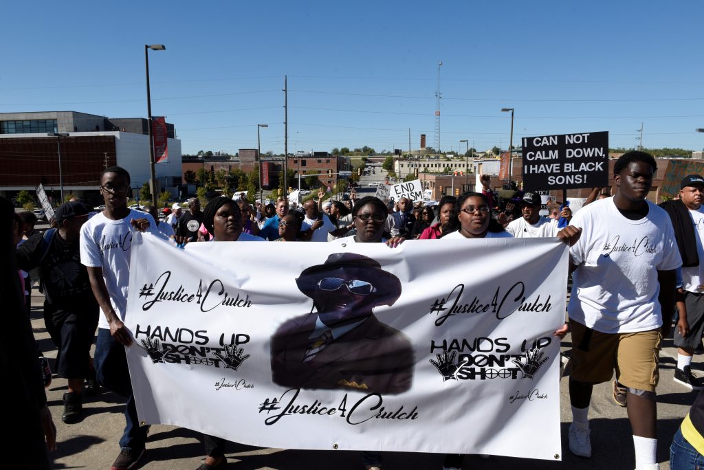 Protesters march towards Tulsa City Hall during a peaceful protest honoring Terence Crutcher who was shot and killed by Tu...