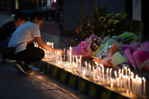 Employees light candles during a memorial for those killed in a casino fire at Resorts World in Pasay City, Metro Manila, Philippines June 2, 2017. REUTERS/Dondi Tawatao - RTX38PJ7
