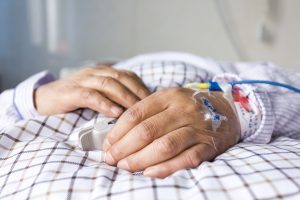 The patient's hand on the bed. Photo by 06photo/via Adobe