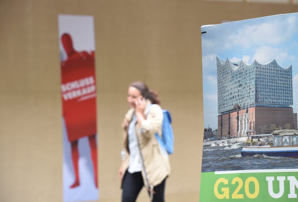 Windows of a German department store are covered with wooden boards before the upcoming G20 summit in Hamburg, Germany, Ju...
