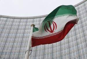 An Iranian flag flutters in front of the International Atomic Energy Agency (IAEA) headquarters in Vienna, Austria. Photo by Leonhard Foeger/Reuters