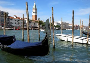 A gondola is pictured in the Grand Canal (Canale Grande) in Venice lagoon with the Campanile belltower in Venice