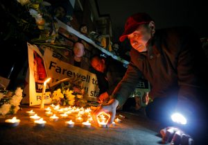 A man lays out a candle tribute to Chinese Nobel Peace Prize laureate Liu Xiaobo, outside China's consulate in Sydney, Australia July 14, 2017. REUTERS/Jason Reed - RTX3BF20
