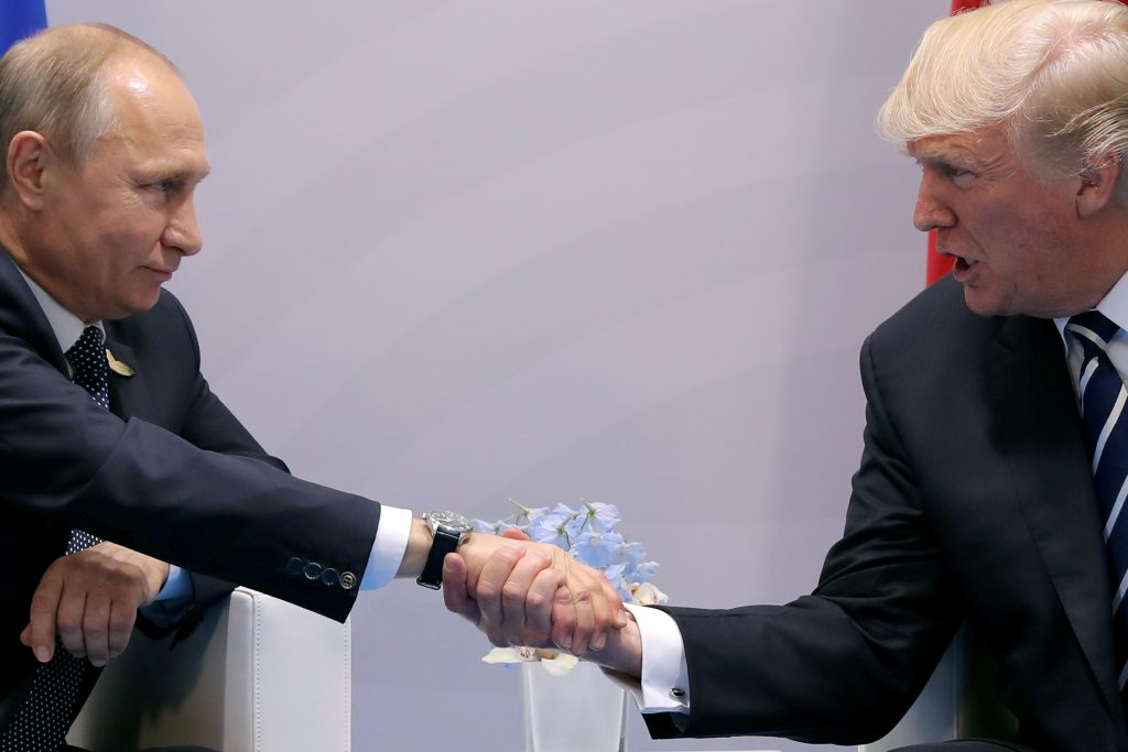 FILE PHOTO - U.S. President Donald Trump shakes hands with Russian President Vladimir Putin during the their bilateral mee...
