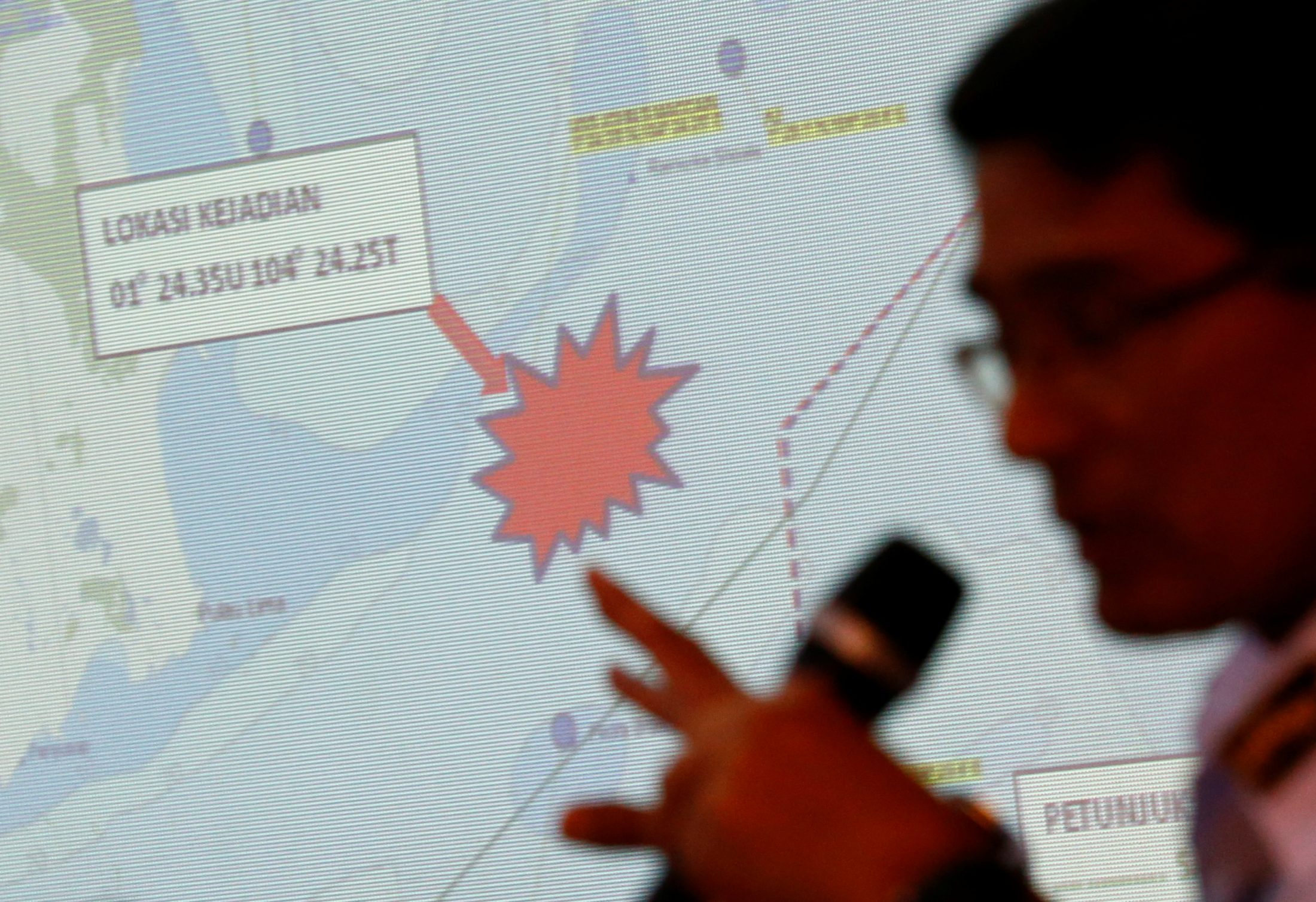 Malaysia Maritime Enforcement Agency (MMEA) officer talks about the area of the search and rescue operations for missing personnel of USS John McCain in Putrajaya, Malaysia. Photo by Edgar Su/Reuters