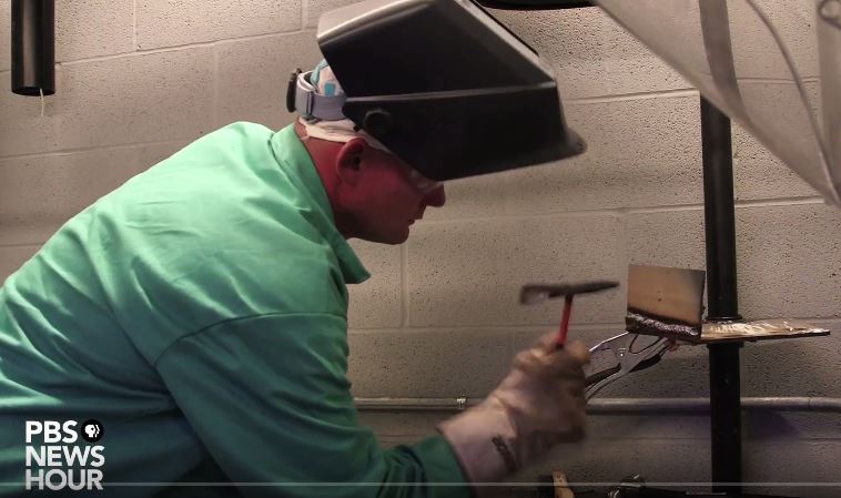 A man in a welding helmet