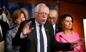 Former Democratic presidential candidate Bernie Sanders speaks to reporters as Senate Democratic Leader Chuck Schumer (2nd R) and House Democratic Leader Nancy Pelosi (R) stand with him following their meeting with U.S. President Barack Obama on congressional Republicans' effort to repeal the Affordable Care Act on Capitol Hill in Washington, U.S., January 4, 2017. REUTERS/Kevin Lamarque - RTX2XJ58