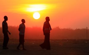 People who fled fighting in South Sudan are seen walking at sunset on arrival at Bidi Bidi refugee's resettlement camp near the border with South Sudan, in Yumbe district, northern Uganda December 7, 2016. REUTERS/James Akena - RTX2V727