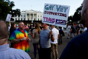 Demonstrators gather to protest U.S. President Donald Trump's announcement that he plans to reinstate a ban on transgender individuals from serving in any capacity in the U.S. military, at the White House in Washington, U.S. July 26, 2017. REUTERS/Jonathan Ernst - RTX3D29Q