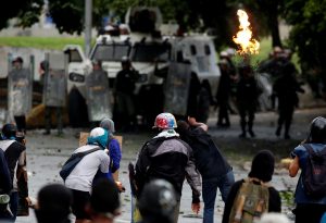 Demonstrators clash with riot security forces while rallying against Venezuela's President Nicolas Maduro's government in Caracas
