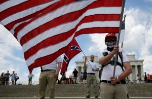 Demonstrator holds a United States flag in front of another waving a Confederate flag as self proclaimed "White Nationalists" and "Alt-Right" activists hold "Freedom of Speech" rally at Lincoln Memorial in Washington