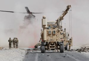 U.S. troops assess the damage to an armoured vehicle of NATO-led military coalition after a suicide attack in Kandahar province