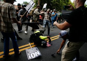 A man hits the pavement during a clash between members of white nationalist protesters against a group of counter-protesters in Charlottesville