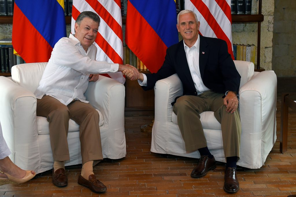 Colombia's President Juan Manuel Santos greets U.S. Vice President Mike Pence after his arrival in Cartagena, Colombia, on...