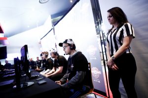 A referee watches over competitors play "Call of Duty: Infinite Warfare" on the Playstation 4, during the Cineplex WorldGaming Canadian Championship Series, an esports video game tournament for $65,000 (CAD) total prize money, in Toronto, Ontario, Canada, March 26, 2017. Picture taken March 26, 2017. REUTERS/Mark Blinch - RTX32WI9