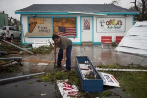 Business owner and resident clears debris from outside his shop which was hit by Hurricane Harvey in Rockport, Texas