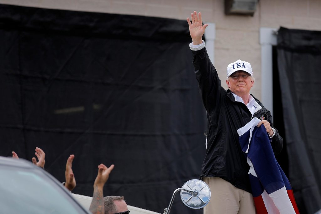 U.S. President Trump waves to the crowd after receiving a briefing on Tropical Storm Harvey relief efforts at a local fire...
