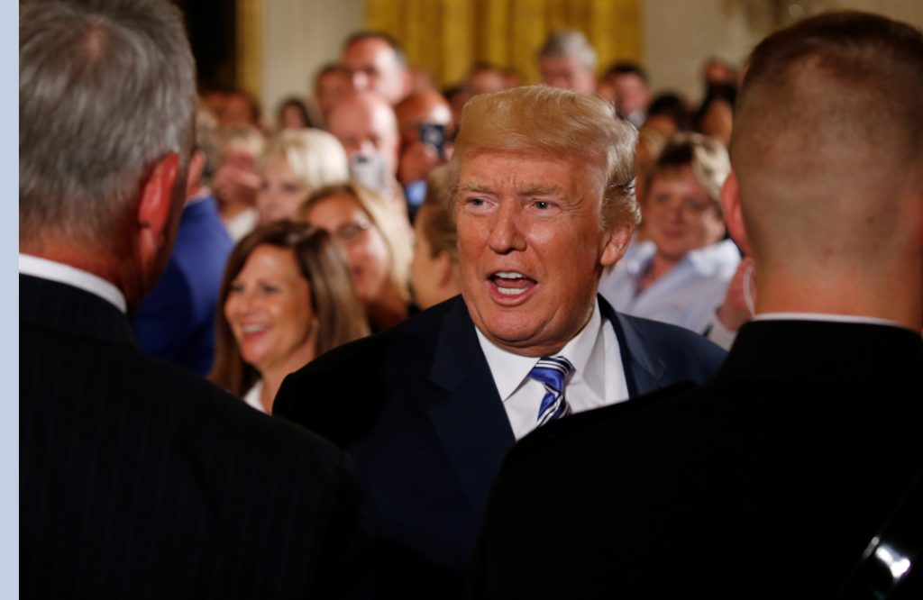 U.S. President Donald Trump greets guests during an event with small businesses in the East Room of the White House in Was...