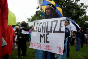 A woman holds a sign calling for her legalization during an August rally by immigration activists CASA and United We Dream demanding the Trump administration protect the Deferred Action for Childhood Arrivals (DACA) program and the Temporary Protection Status (TPS) programs, in Washington, D.C. Photo by Joshua Roberts/Reuters