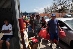 People queue at a gas station to fill up their fuel containers, after the island was hit by Hurricane Maria, in San Juan, Puerto Rico September 28, 2017. REUTERS/Alvin Baez - RC1DEFAA5E70