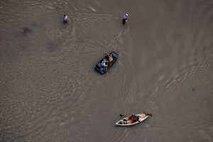 Residents move through flood waters brought by Tropical Storm Harvey in Northwest Houston