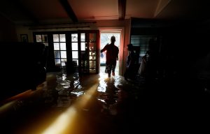A family that wanted to remain anonymous moves belongings from their home flooded by Harvey in Houston
