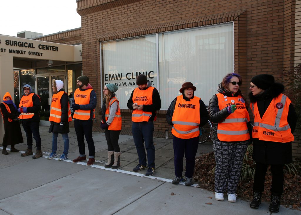 Escorts who ensure women can reach the clinic lineup as they face off protesters outside the EMW Women's Surgical Center i...