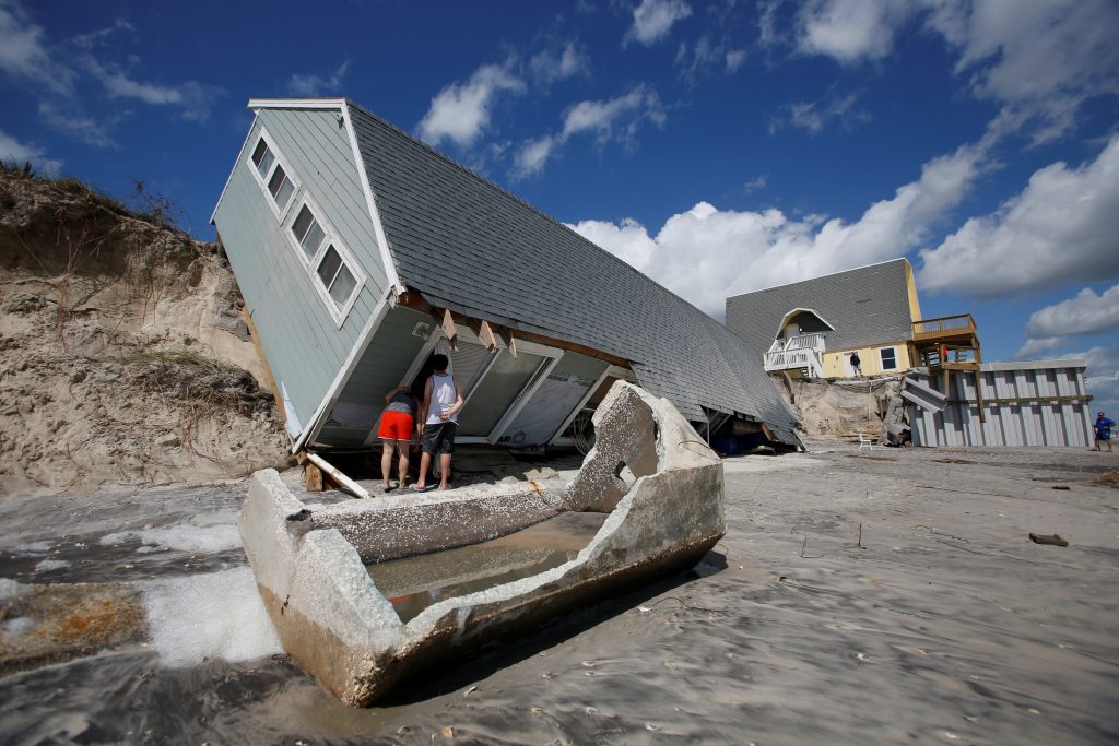 Local residents look inside a collapsed coastal house after Hurricane Irma passed the area in Vilano Beach, Florida. Photo by Chris Wattie/Reuters